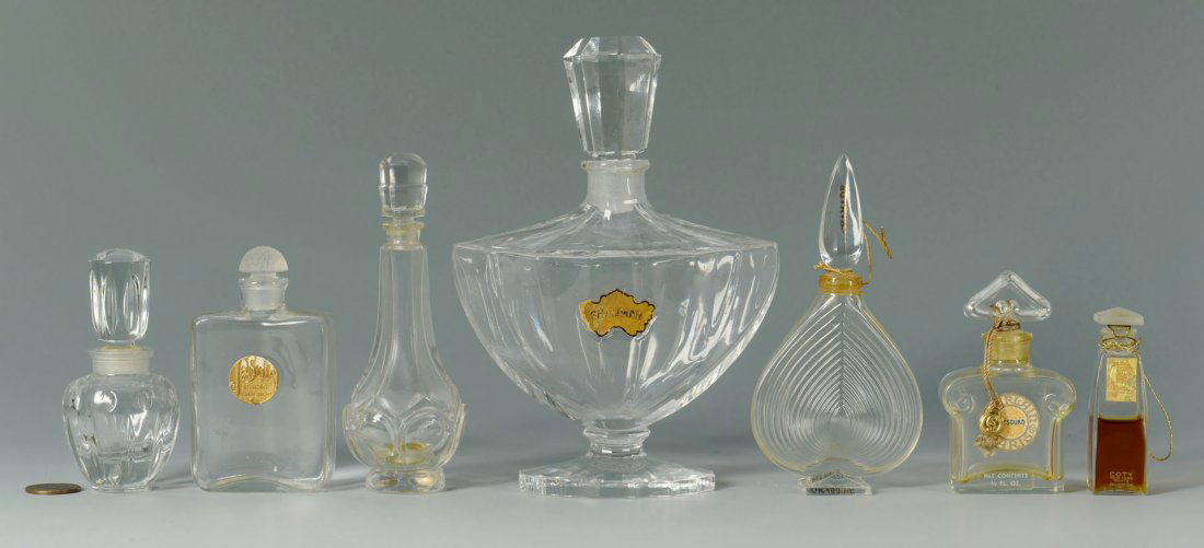 7 Vintage Perfume Bottles inc. Baccarat for Guerla: 7 Vintage French glass perfume bottles. Includes a large Guerlain Shalimar bottle with paper label, footed and scalloped oval base and faceted stopper, etched Baccarat mark on underside, 6-1/2"H;