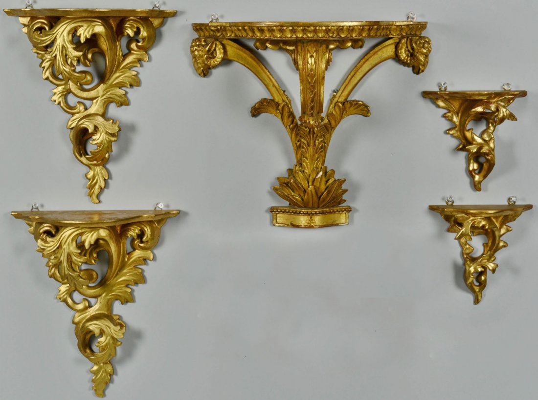 Grouping of 5 Gilt Sconces: Grouping of five gilt wood and composition sconces with classical scrolled leaf designs. Ranging in size from 5 3/4" H x 5 3/4" W to 11 1/4" H x 13 1/8" W. 20th century.