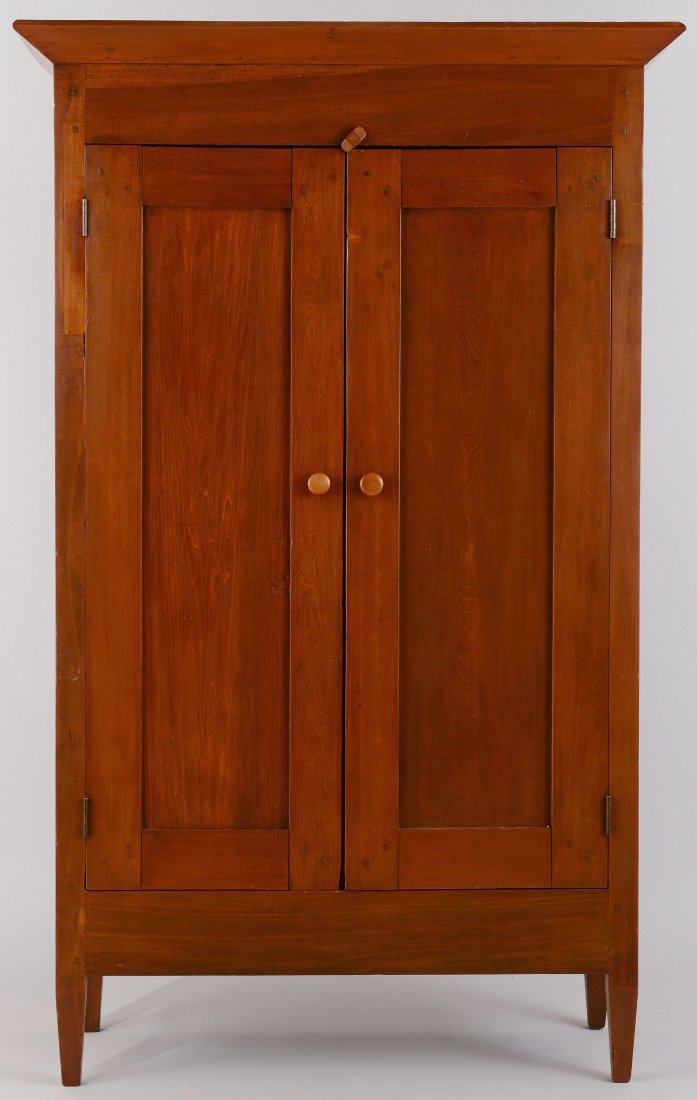 Tennessee Cherry Wardrobe: Middle Tennessee wardrobe, stained poplar wood. Canted cornice over a rectangular case with pegged construction featuring two paneled doors, plain sides, paneled back, and four square tapered legs. Ro