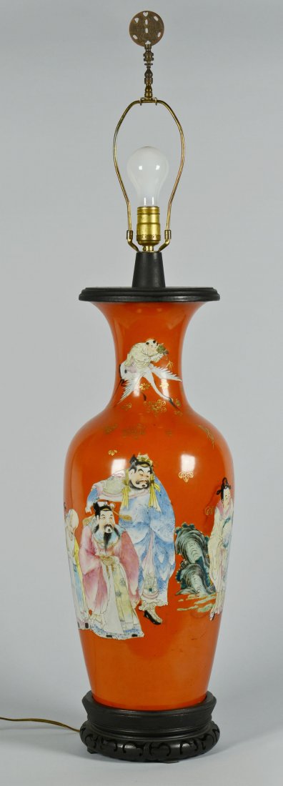 Chinese Famille Rose Porcelain Lamp: A large Chinese Famille Rose porcelain floor vase, converted to a lamp. Decorated with immortals, including one figure atop a flying crane, on a coral colored ground with gilt floral accents. Fitted w
