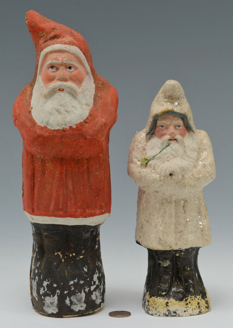 Two Early Santa Belsnickles: Two early Santa Claus belsnickles. 1st item - Santa paper mache belsnickle with red robe, black base. Condition - chip to tip of hood, some losses around staples at side seams, missing fir tree. 10 1/