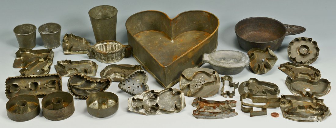 Group of Tin Cookie Cutters, Molds, Porringer: Large grouping of 22 early tin cookie cutters, 1 large tin heart shaped container, 3 tin candle holders, 3 tin cups, 2 chocolate molds, and an iron porringer marked Kenrick (possibly Archibald Kenrick