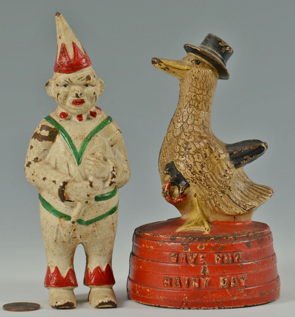 2 Cast Iron still banks: Clown and Duck: Two cast iron still banks. 1st item: "Save for a Rainy Day" bank featuring a duck wearing a hat, atop a red tub with raised letters, attributed to Hubley. 5-5/8". 2nd item: Clown bank f