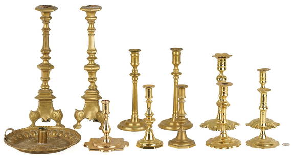 Collection of 12 early Brass Candlesticks: A collection of twelve (12) early Brass Candlesticks, including one pair of Ecclesiastical altar candlesticks (height: 16 inches) and one pair of plain tapered column candlesticks with round bases