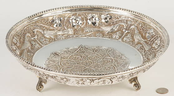 Sterling Silver Footed Bowl, Peacock Decoration: Large Middle Eastern shallow sterling silver bowl. Beaded rim and wide repousse border featuring twin peacocks drinking from a chalice on a ground of meandering leaves, berries and vines, the center