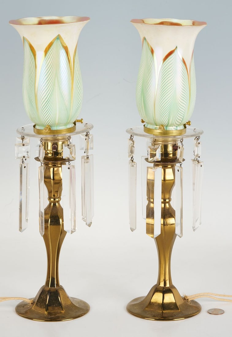 Pair of Lamps with Pulled Feather Shades attrib. Steuben: Pair of brass candlestick lamps with pulled feather art glass shades attributed to Quezel, accented with glass prisms. 16 in H. Mid 20th century. Additional high-resolution photos are available at cas