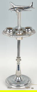 Art Deco Airplane Lighted Smoking Stand: Lighted Art Deco period smoking stand, possibly by Metalcraft Manufacturing, having a chrome finish with a shaped tier fitted with removable ashtray and lidded waste containers