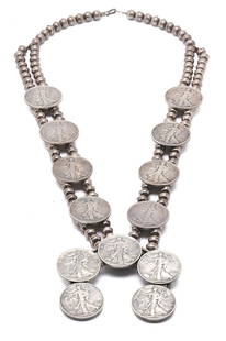 Navajo Liberty Coin Squash Blossom Necklace: A Native American sterling silver Liberty Coin squash blossom necklace consisting of a double strand of silver beads with eight (8) Walking Liberty half dollars blossoms and a Naja consisting of five