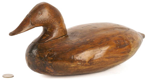 Early John B. Graham Canvasback Decoy: An early John B. Graham (1822-1912, Charlestown, MD) carved canvasback drake decoy, all paint removed and branded "Dr. Taylor" twelve times. 6 1/2 in. H x 14 1/2 in. L. Circa 1860s. Note: This rare de