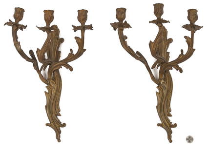 Pair of Continental Rococo Bronze Sconces: Pair of Continental Rococo style bronze sconces, each with scrolling, naturalistic arms supporting three bud form candle cups. 16 in H x. 11 in W. Early 20th century. Additional high-resolution
