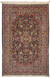Persian Kirman or Kerman Carpet, 6 ft. x 9 ft.: Persian Kirman or Kerman carpet, wool on cotton, central blue ground with an elongated foliate medallion design, and foliate spandrels, all within three primary foliate borders. Woven in blue, red,