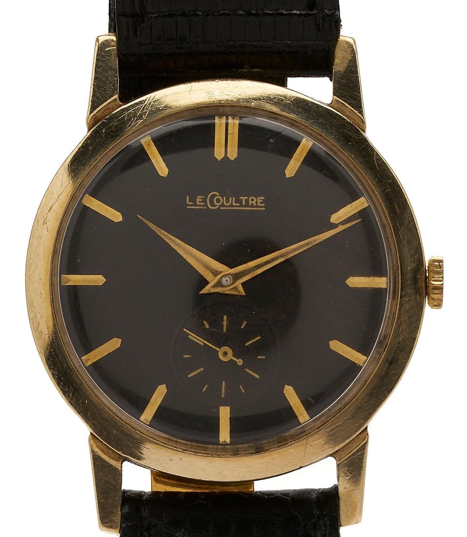 Vintage 14K Gold Le Coultre Wrist Watch: Vintage 14K yellow gold Swiss Le Coultre 480/CW caliber mechanical wristwatch, 17 jewels, manual wind, 33 mm. Black dial with seconds dial and gilt markers and hands. Serial # 05602. Fitted with a bla
