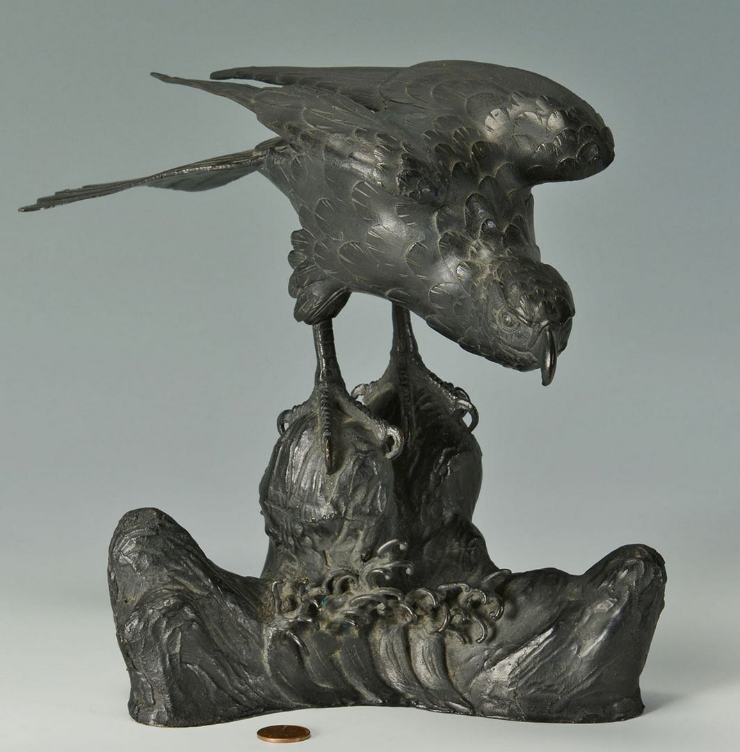 Bronze Bald Eagle sculpture, Chinese: Sculpture of a bald eagle perched on oceanside rocks, cast bronze with black patina. Signed with three Chinese characters on the base verso. 9-3/16" high x 11" x 5-1/2". Provenance: Pur