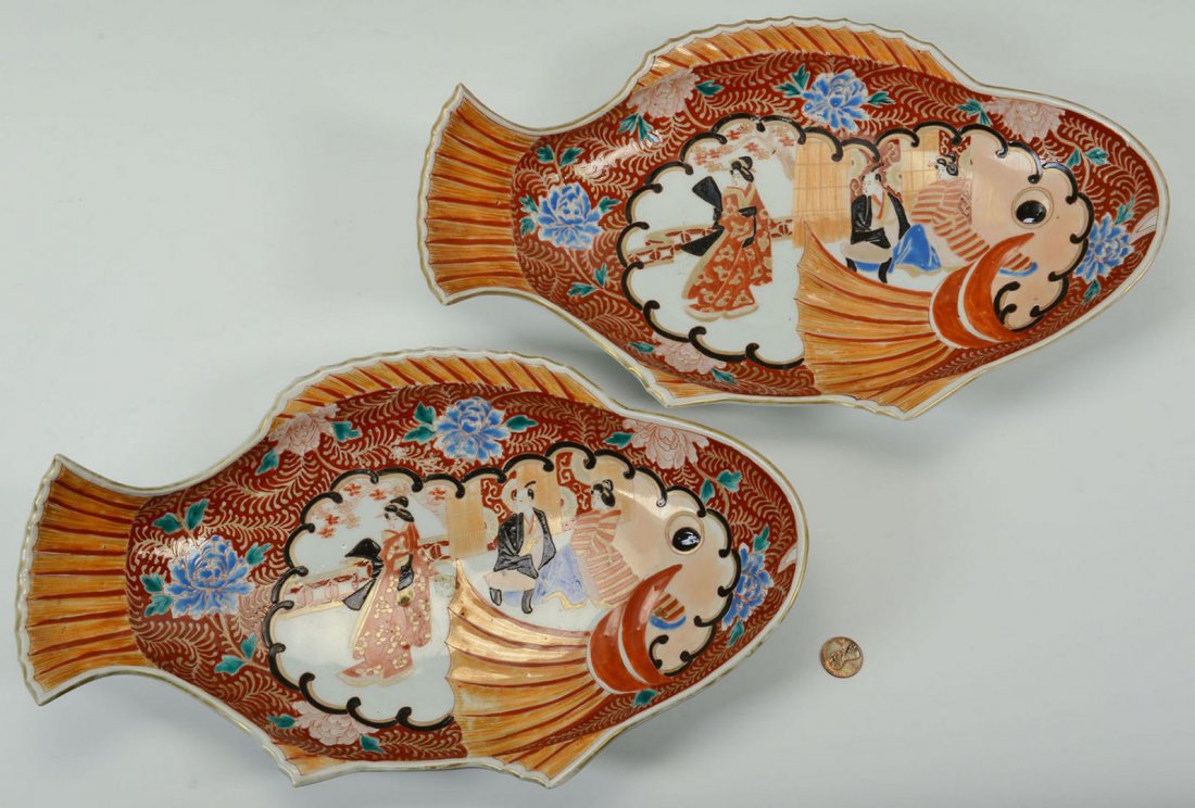 Pair of Japanese Imari Fish Platters: Pair of Imari fish-shaped platters with matching figural scenes on the body surrounded by chrysanthemum decoration. Undersides have floral decoration and maker's mark. 8-1/8" x 13-1/4".