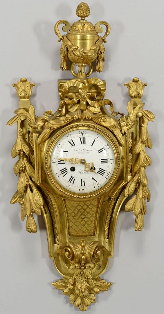 Jules Graux Gilt Bronze French Wall Clock: Jules Graux gilt bronze French wall clock, in the Louis XIV style with foliate swags and an urn finial. The enameled dial marked "Jules Graux Bronze d'Art, Paris". Retains the 19th century works and a