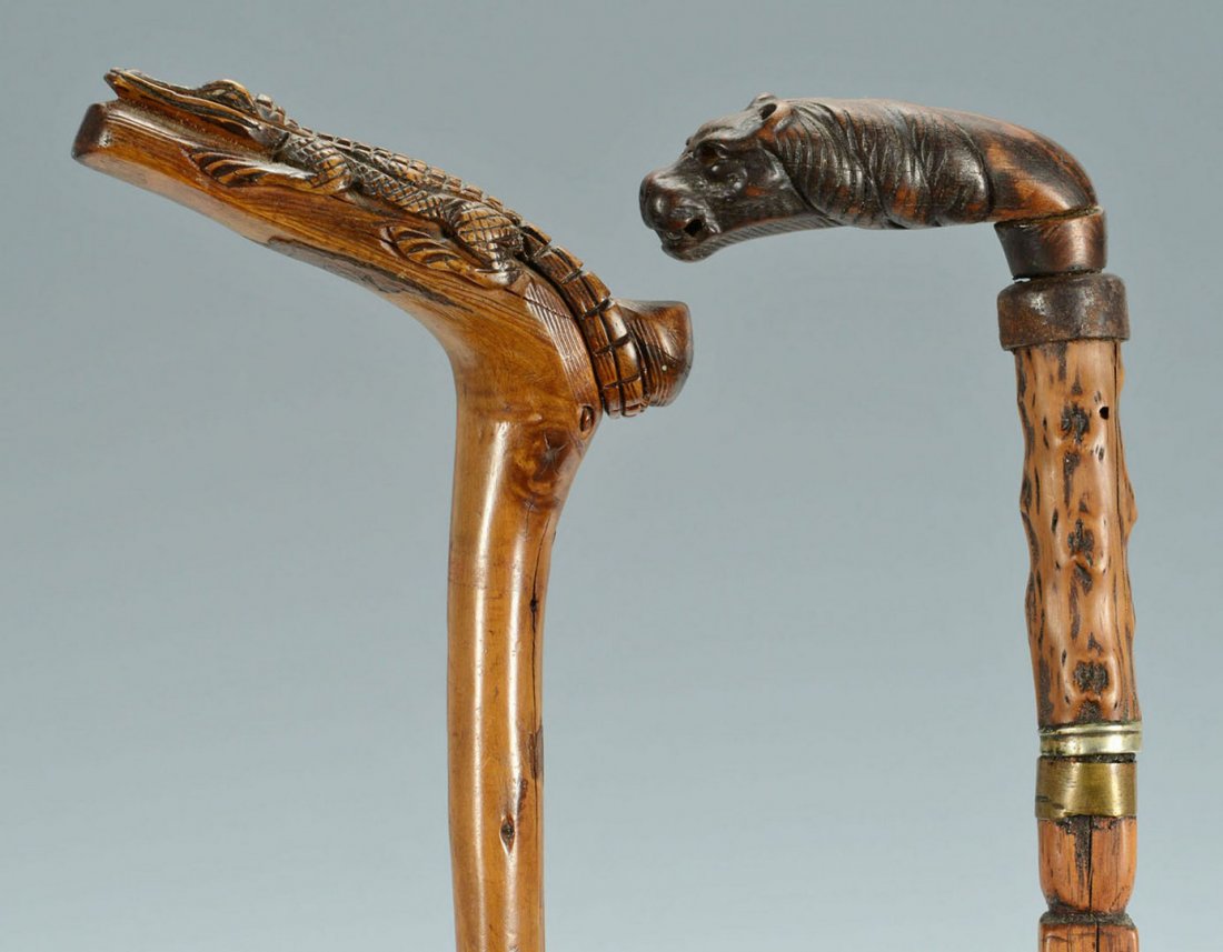2 Folk Art Canes, Alligator & Dog/Griffin: 2 Folk Art canes or walking sticks, one having an alligator carved handle and metal ferrule (36" L) and the other with a carved dog/griffin head handle with additional carving on the shaft (33&qu