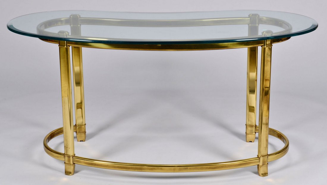Mastercraft Kidney Shaped Brass Writing Table: Mastercraft kidney-shaped brass writing table with beveled glass top. 28 1/2" H x 27 1/4" D x 59 3/4" W. 1970s.