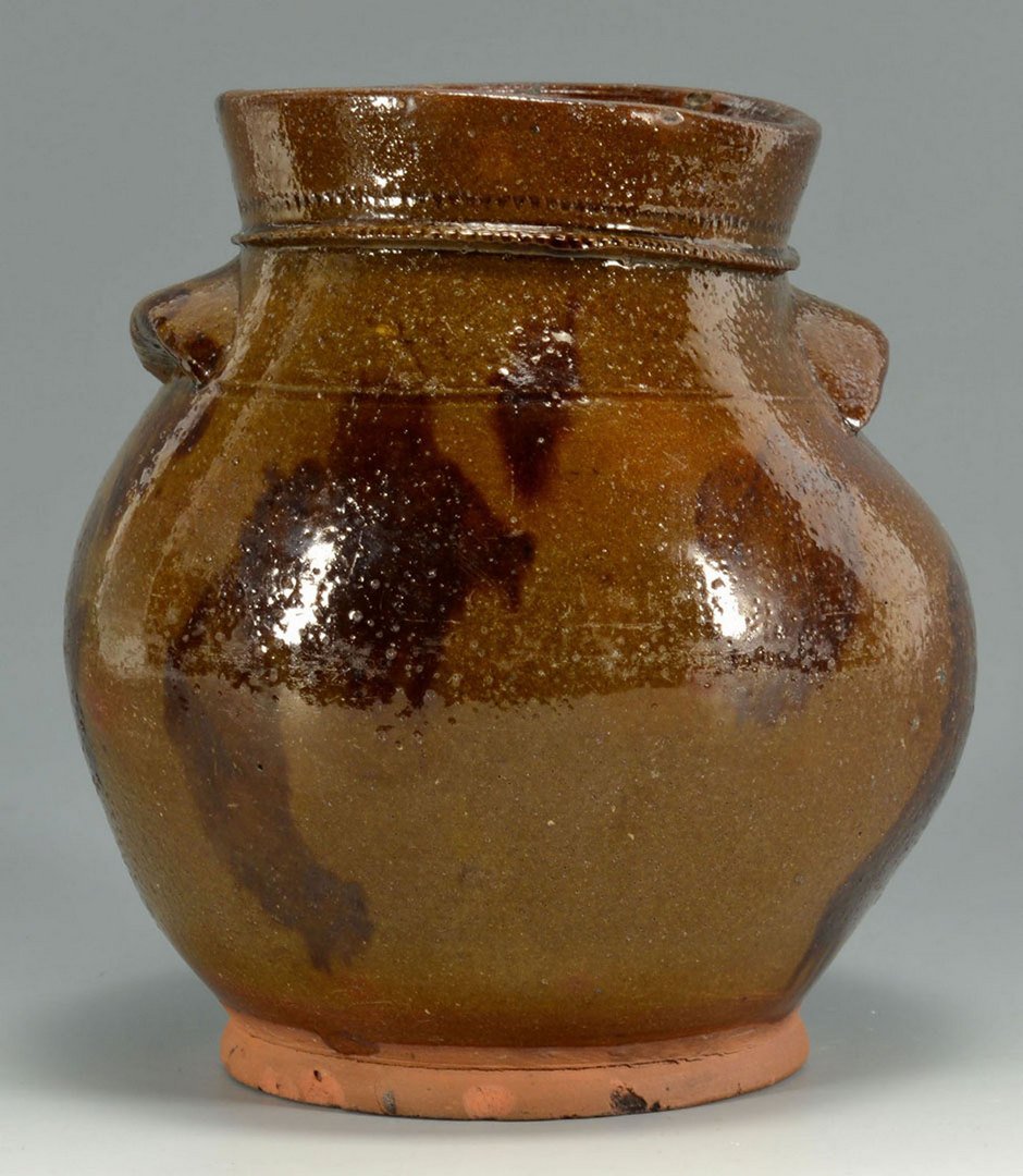 New England Redware Jar: New England redware jar, ovoid form with applied handles, incised decoration to rim and manganese splotches. 8" H. 1st half 19th century.