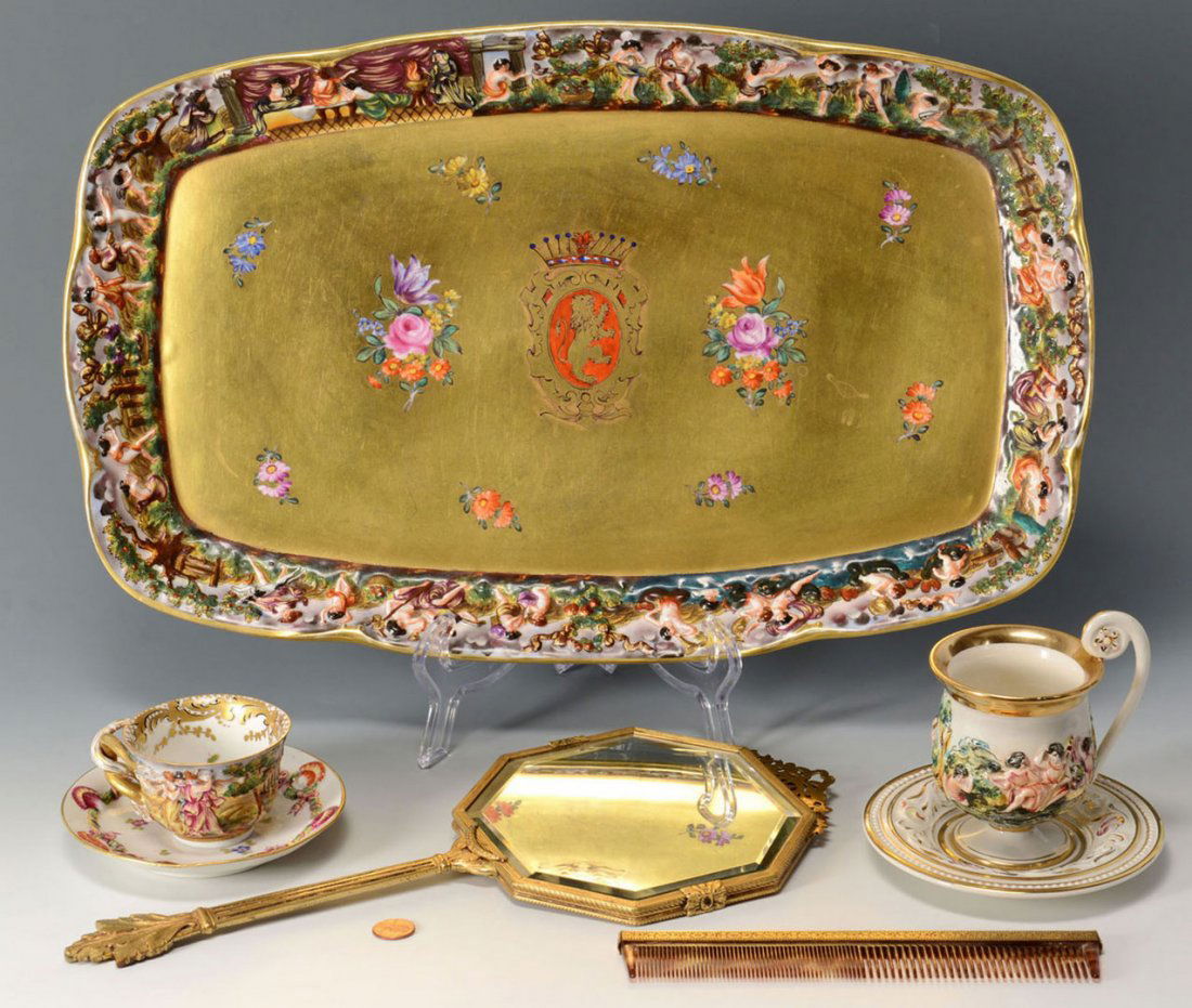 5 Capodimonte items inc. armorial tray: 1st item: Capo di Monte porcelain dresser tray or platter, figural relief border with Bacchinalian images and a gold center handpainted with flowers and a large armorial crest of lion surrounded by a