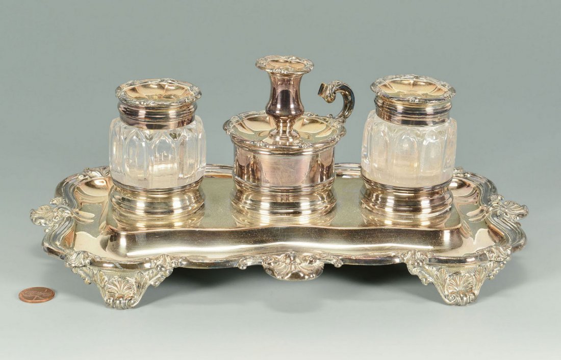 Old Sheffield Standish, Matthew Boulton: Old Sheffield Plate (silver on copper) inkwell stand with gothic arched glass bottles flanking a diminutive chamberstick capping a compartment for sealing wax, on a cartouche shaped base ending in she