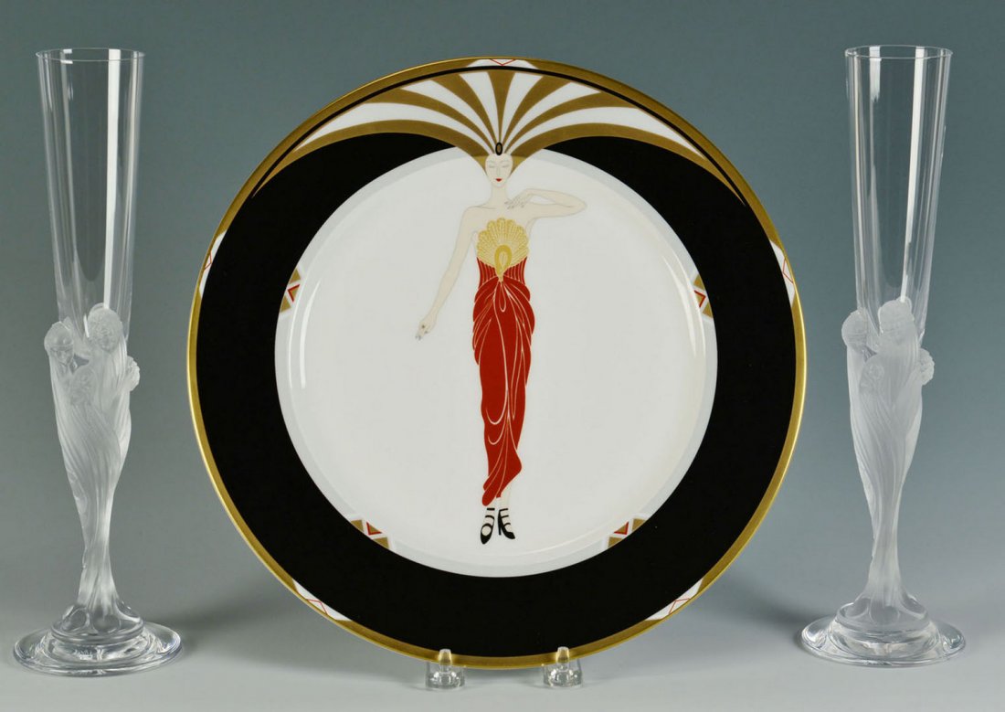 2 Erte Figural Champagne Flutes & Plate: Two Erte figural crystal champagne flutes, signed on base "Erte, France" (11 3/4" H) together with an Erte signed porcelain plate, Le Soleil Ebony pattern (12" dia).