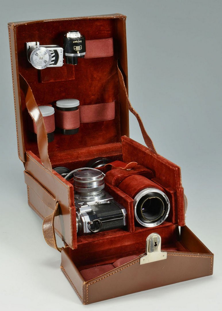 Zeiss Ikon Contax Camera w/ Accessories: German Zeiss Ikon Contax camera, housed in the original brown leather case. Numerous accessories including a Bigon No. 831454 1:28 f=35 mm lens, a Sonnar No. 1897484 1:4 f=135 mm lens, a Sonnar No. 68