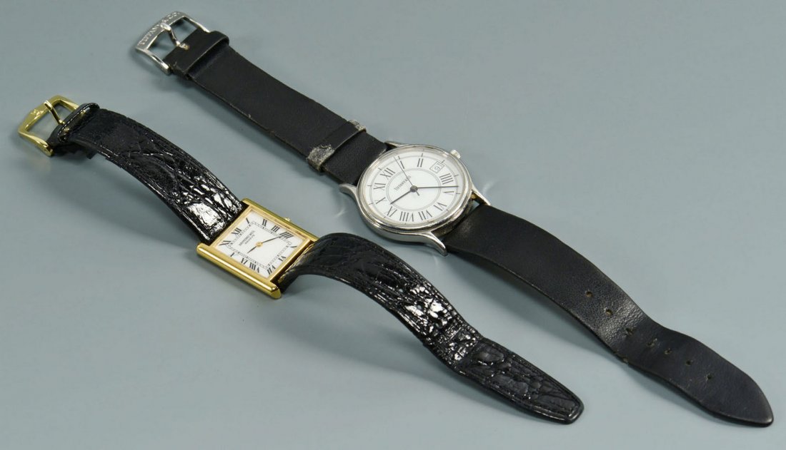 Tiffany & Raymond Weil Men's Wristwatches: Two Men's designer wristwatches. 1st item: Tiffany & Co. Men's stainless steel , water resistent wristwash, #030202872, round white dial with black Roman numerals and date. 1-1/4" W. Tiffany & Co