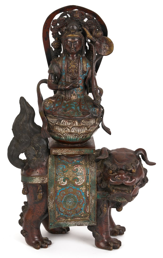 Chinese Bronze & Champleve Statue, Guanyin w/ Foo Dog & Carved Stand: Chinese bronze and champleve sculpture depicting Guanyin, the Bodhisattva of compassion, atop a lotus blossom on the back of a Foo Dog or Guardian Lion. All on a later carved wooden stand. B
