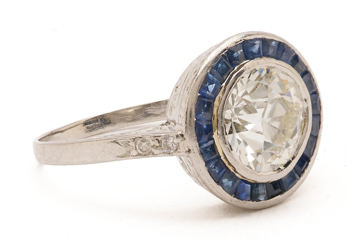 Platinum Diamond & Sapphire Ring: Ladies' platinum Art Deco ring featuring one (1) Euro cut diamond approximately 1.87 carats, Clarity-VS2, Color-J, accented by four (4) round brilliant cut melee diamonds and twenty-one (21) natural