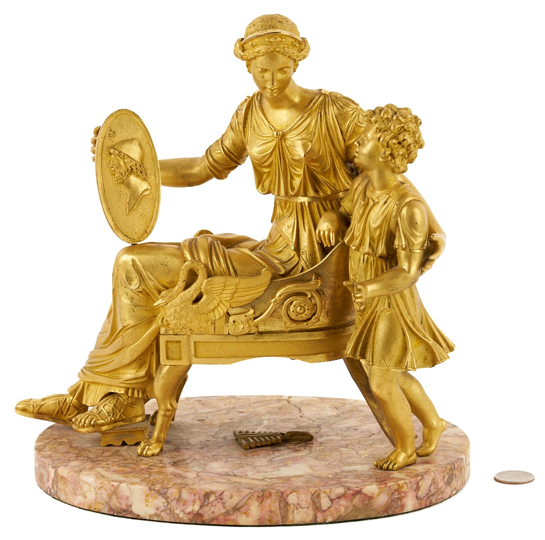 French Empire Gilt Bronze Figural Sculpture, Mother & Child: French Empire gilt bronze sculpture depicting a mother seated in a chair with a shield in her left hand bearing the bust of a man and her son standing to her left side, both attired in Classical