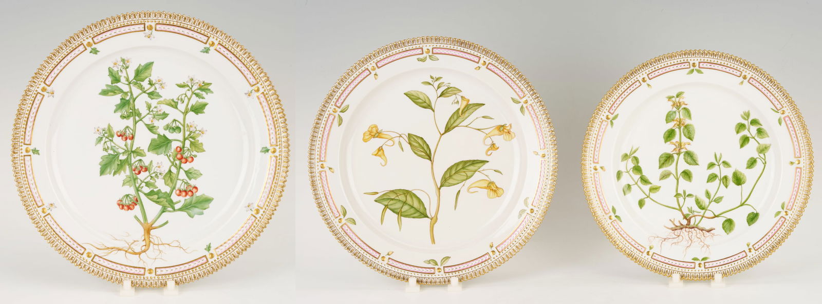 3 Royal Copenhagen Flora Danica Serving Platters: Assortment of three (3) Royal Copenhagen Flora Danica serving platters, each with a gilt-rimmed edge and marked on the underside with the Latin botanical name. One (1) round platter (14 in. dia.) mark