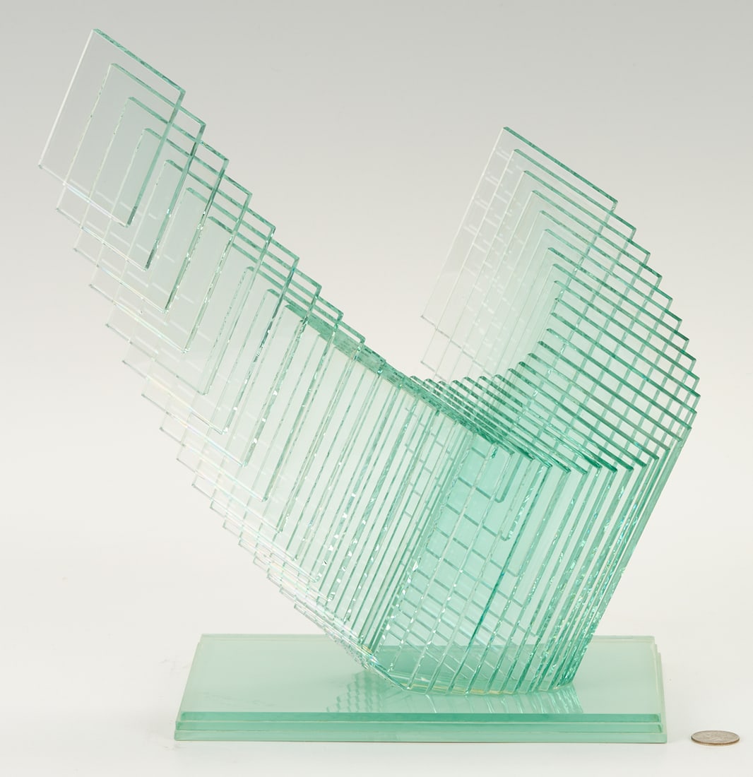 Niyoko Ikuto Green Glass Sculpture: Niyoko Ikuta (Japanese, b. 1953) abstract green glass sculpture comprised of layered panes of glass joined in a wing design and mounted onto a stepped glass vase. Etched signature and date of 1995 in