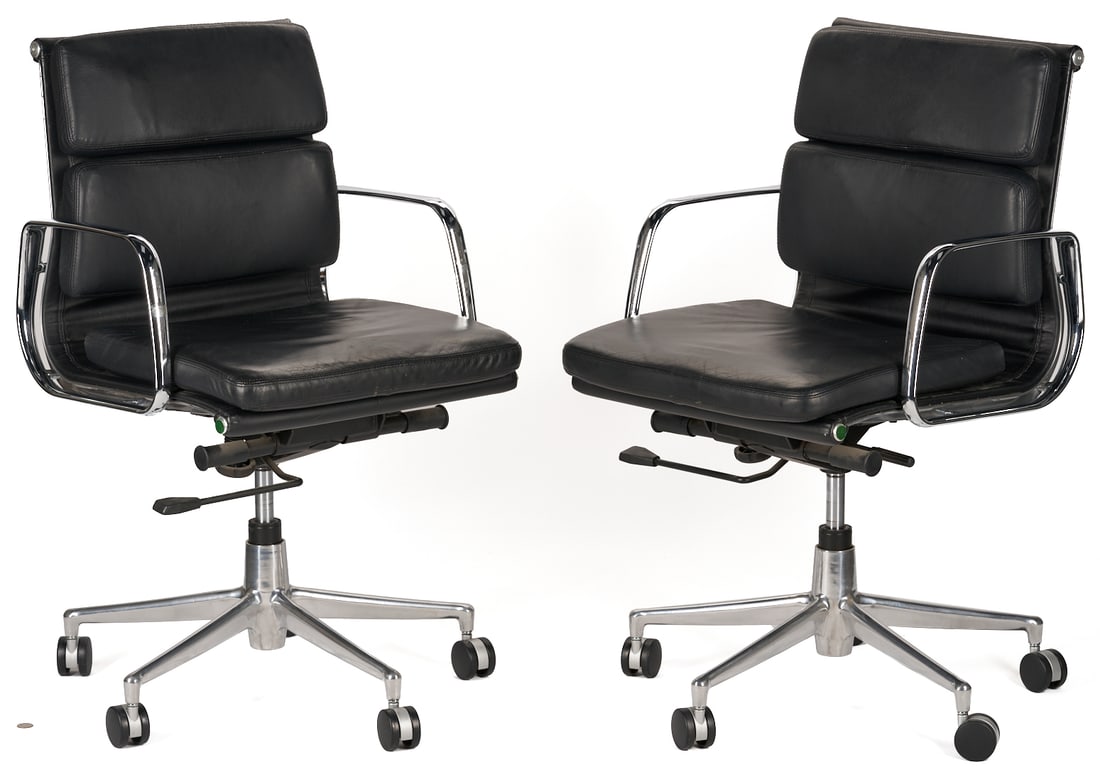 Pair of Eames/Herman Miller Soft Pad Low Back Arm Chairs: Pair of Eames for Herman Miller Soft Pad Alu Low Back arm chairs, comprised of padded black leather cushions on a 5-star chrome base with castors, adjustable height cylinder, and tilt mechanisms. Lack
