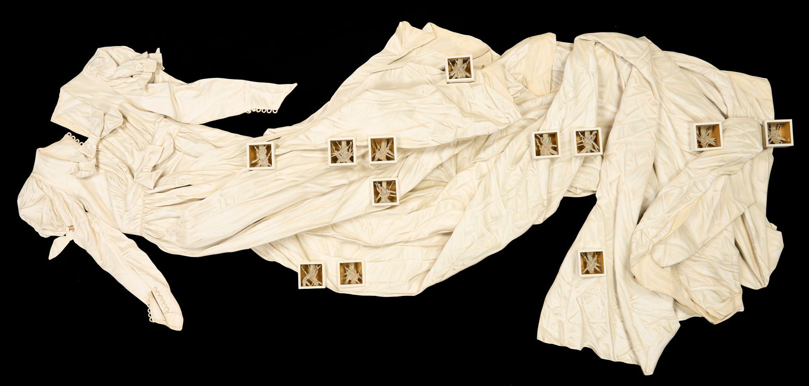 Ron Isaacs Trompe L'oeil Sculpture, Passages: Ron Isaacs (Kentucky/Ohio, 20th century) acrylic on birch plywood Trompe l'oeil sculpture titled "Passages" depicting a long white wedding dress with boxes of barbed wire inset into the skirt of the