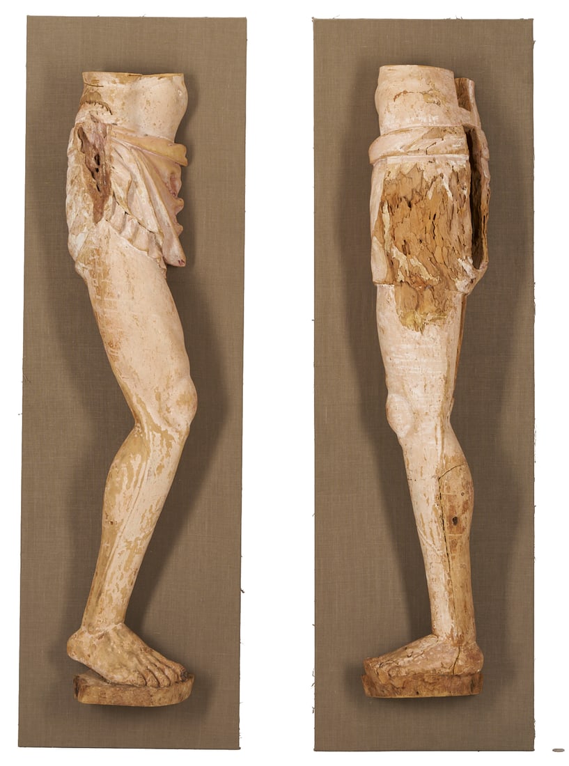 Pair 18th C or earlier Life Size Carved Leg Sculpture Fragments: Two carved wooden life sized leg fragments, likely from a large Continental crucifix sculpture, 18th century or earlier, each mounted for display to a linen lined board in a protective
