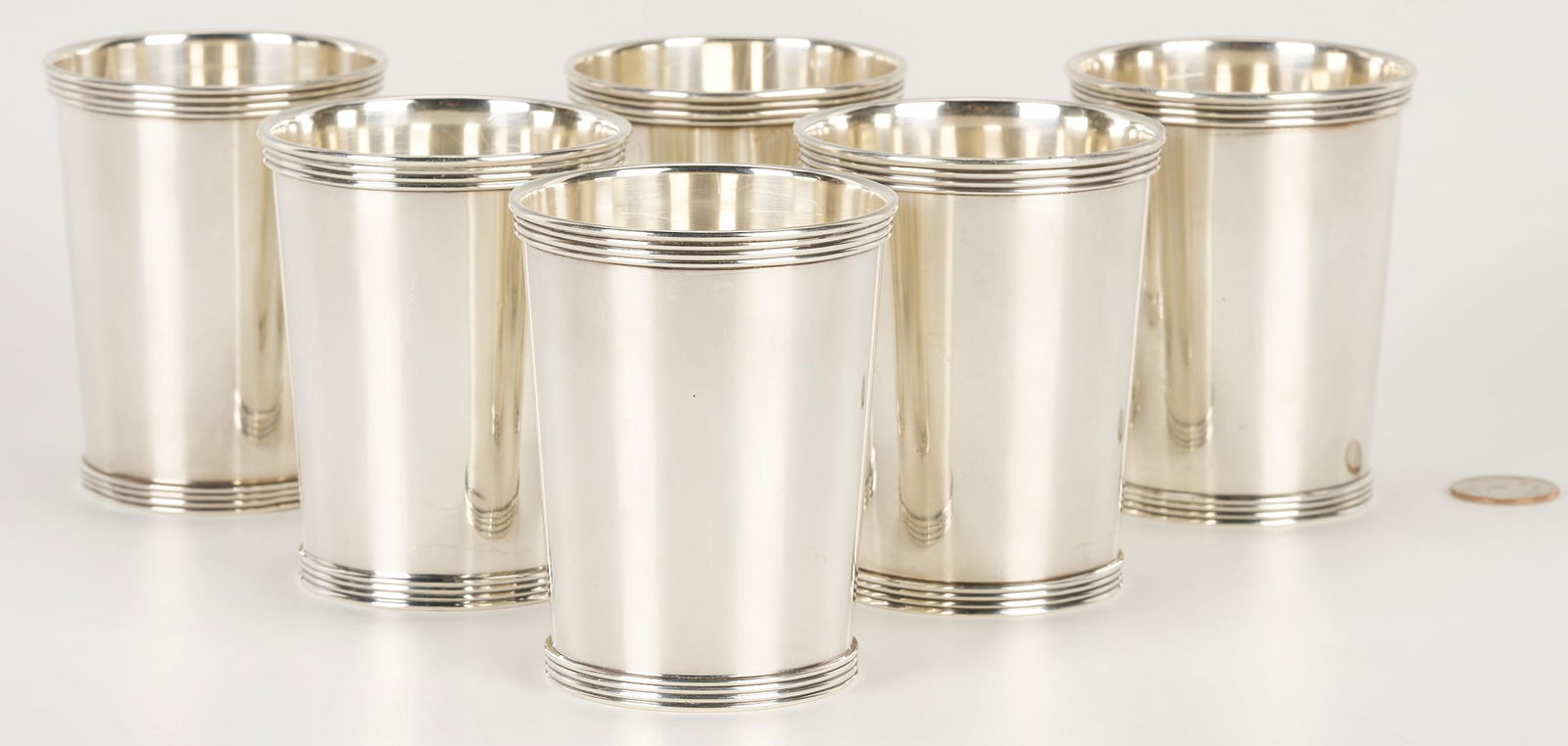 Set of 6 International Sterling Silver Julep Cups: Set of six (6) sterling silver mint julep cups, all marked for International Sterling, P699 and having tapered sides with reeded rims and foot rings. No monograms or removals. 3 3/4 in H, 25.71