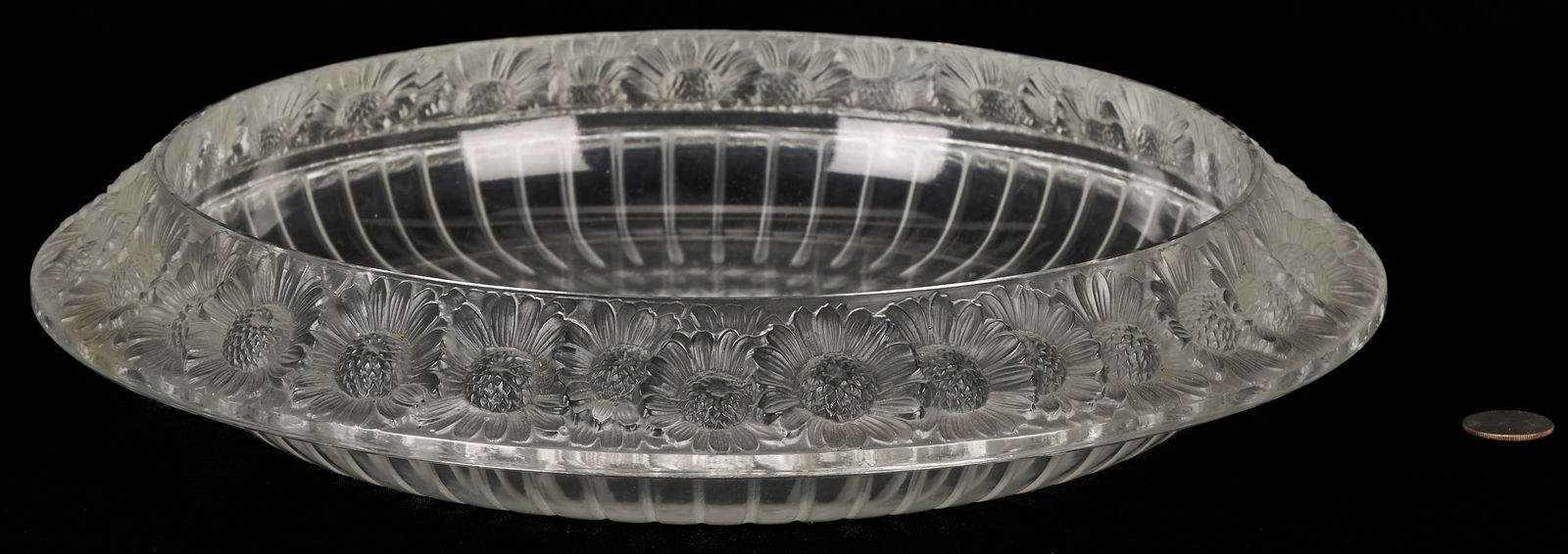 Lalique Crystal Marguerites Centerpiece Bowl: A Lalique crystal centerpiece bowl in the Marguerites pattern, featuring daisies in relief around the rim. Signed "Lalique France" to underside. 14 in. D x 3 in. H. PROVENANCE: The estate of
