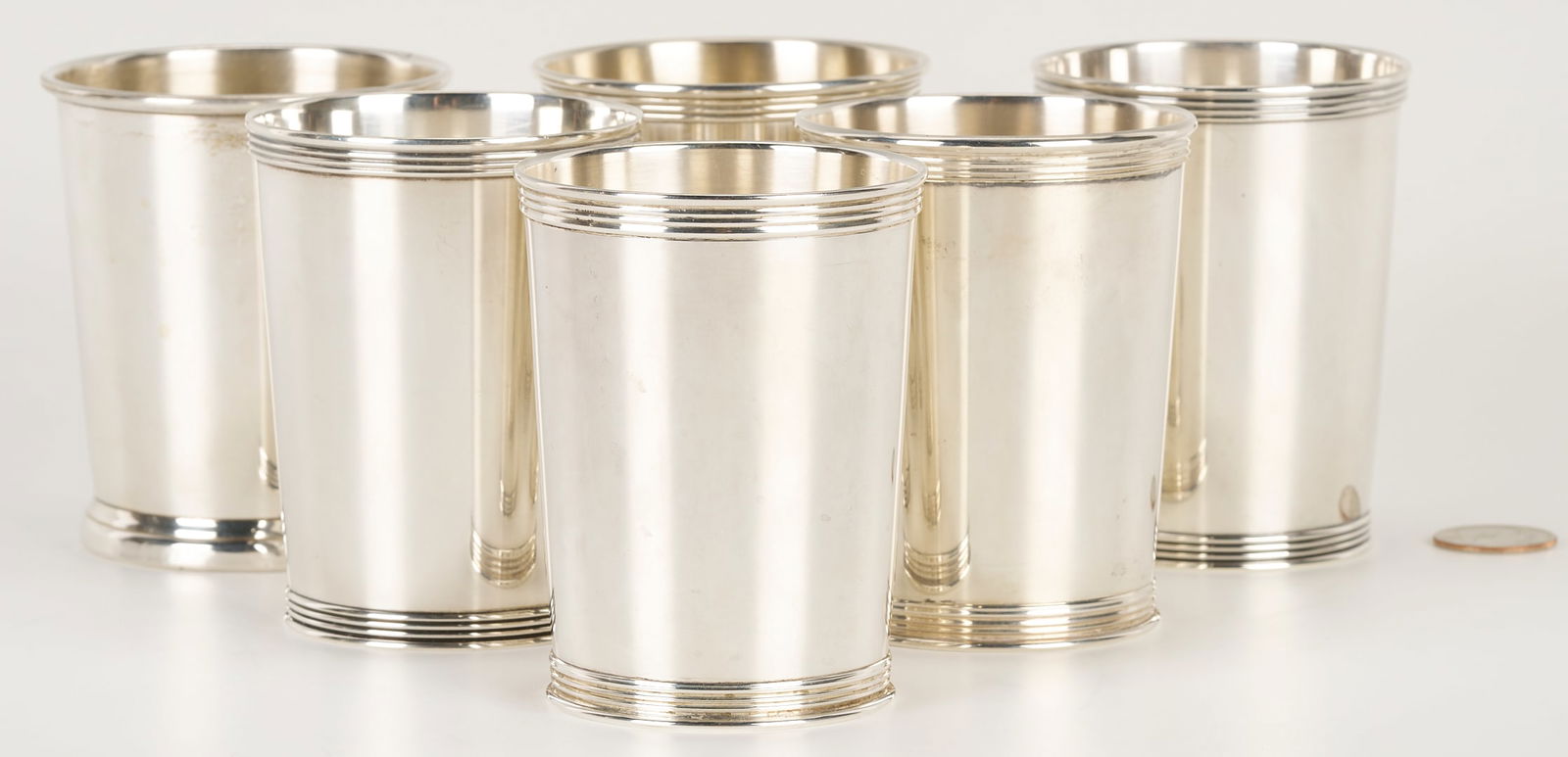 6 Sterling Silver Julep Cups by Assorted Makers: Six (6) sterling silver mint julep cups. Includes four (4) matching Baker Manchester cups with reeded rims and foot rings, and one (1) similar Gorham cup, plus one (1) Web sterling cup with