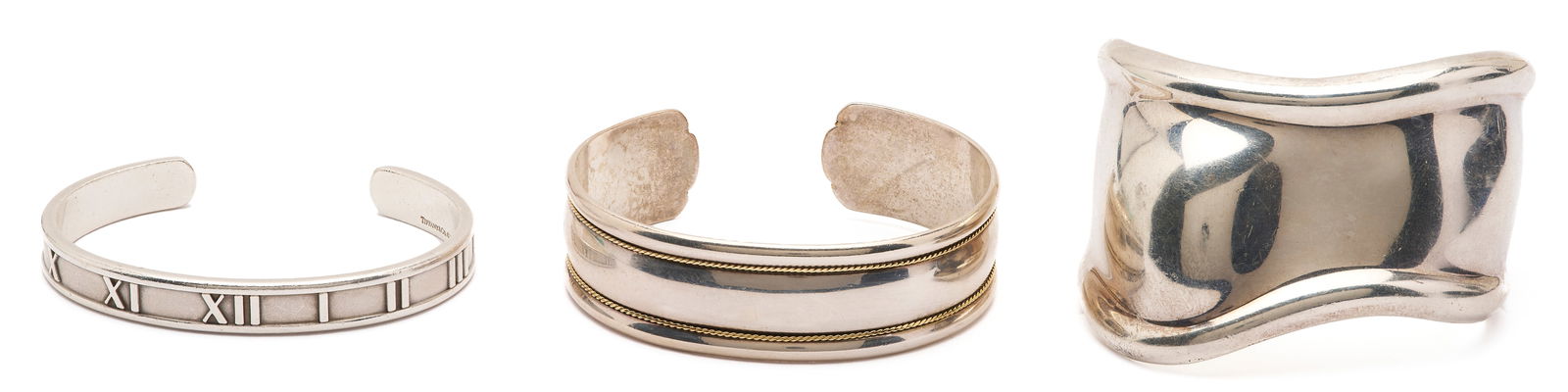 3 Tiffany Sterling Cuff Bracelets: Group of three (3) Tiffany & Company sterling silver cuff bracelets, including an Elsa Peretti-designed small "Bone" cuff bracelet dated 1978, a sterling and 18K 17mm cuff bracelet, and