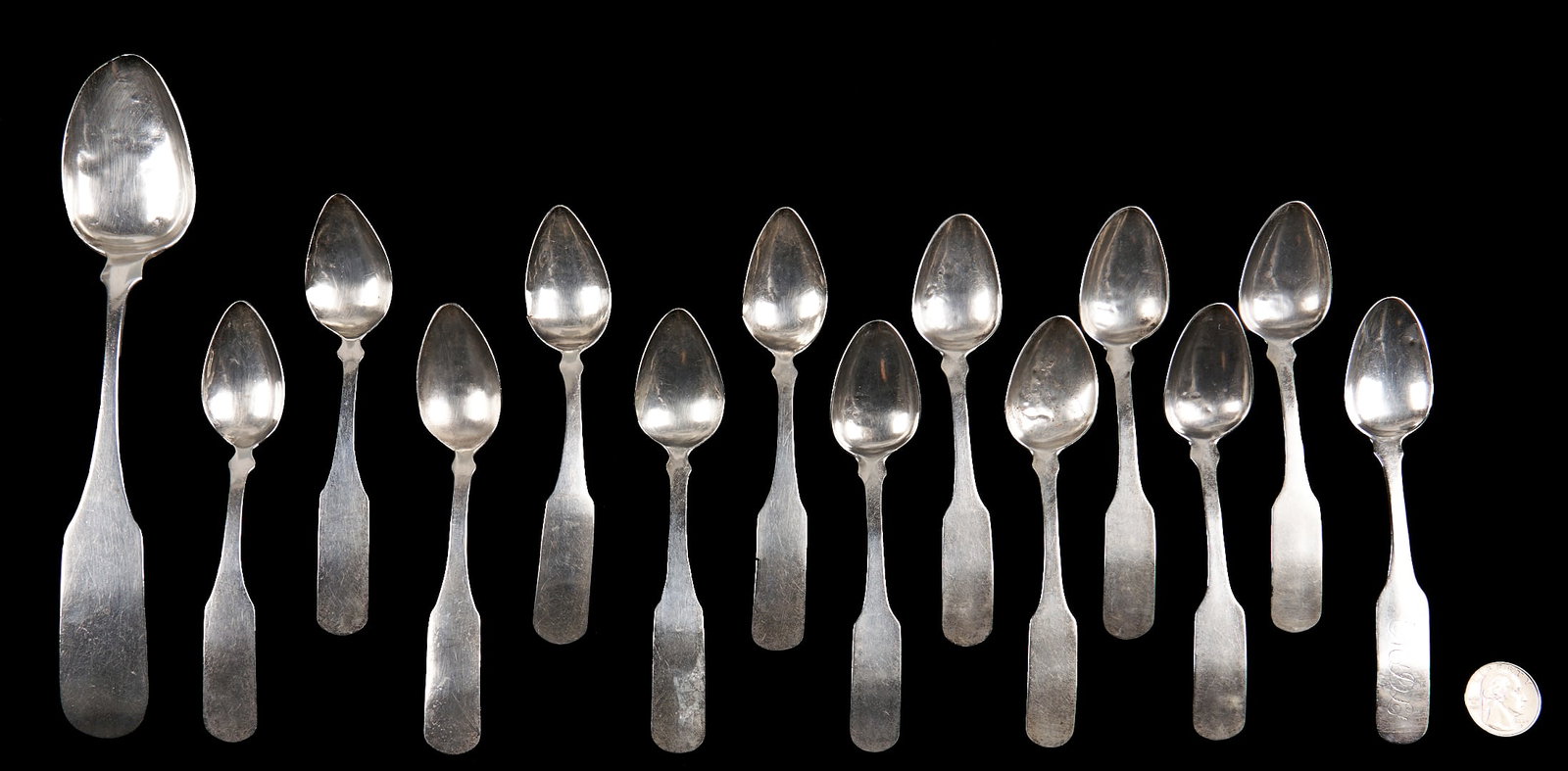 14 East Tennessee Coin Silver Spoons, J.B. Wells: Fourteen (14) coin silver spoons, including 13 teaspoons and 1 tablespoon with reverse fiddle ends and the maker's mark "J.B. Wells" within a rectangle for James B. Wells