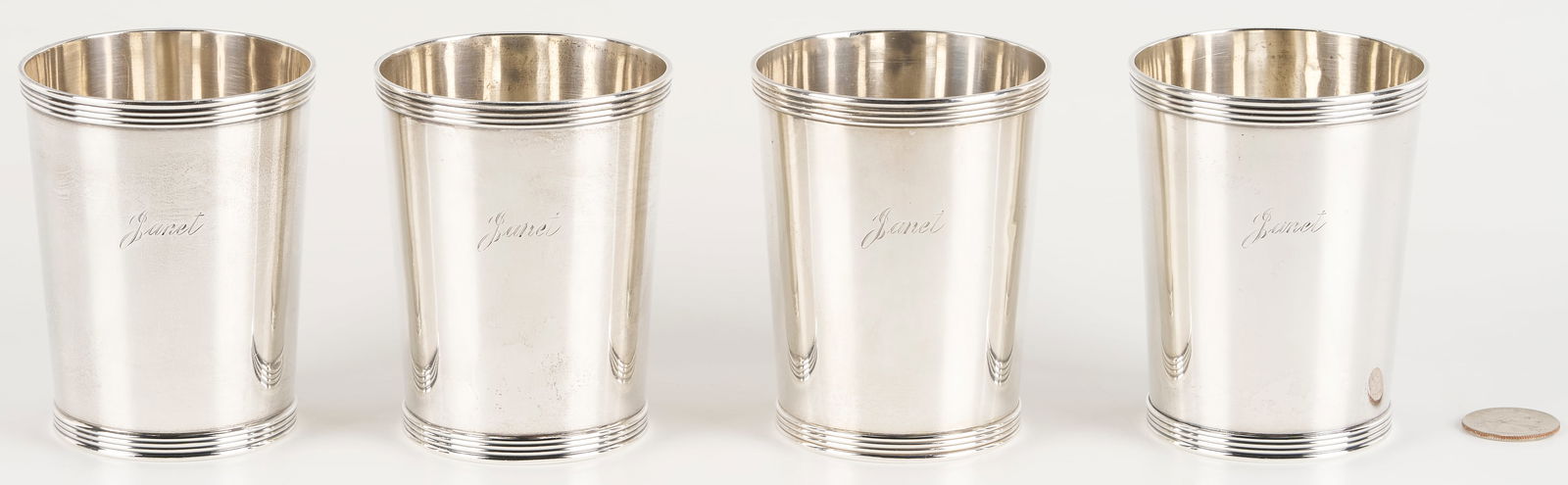 4 Sterling Julep Cups: Four (4) sterling silver mint julep cups with reeded rims, marks for Frank Smith Silver Co., all monogrammed "Janet. " 14.68 oz troy. 3 5/8 in. H. Mid 20th century. Additional