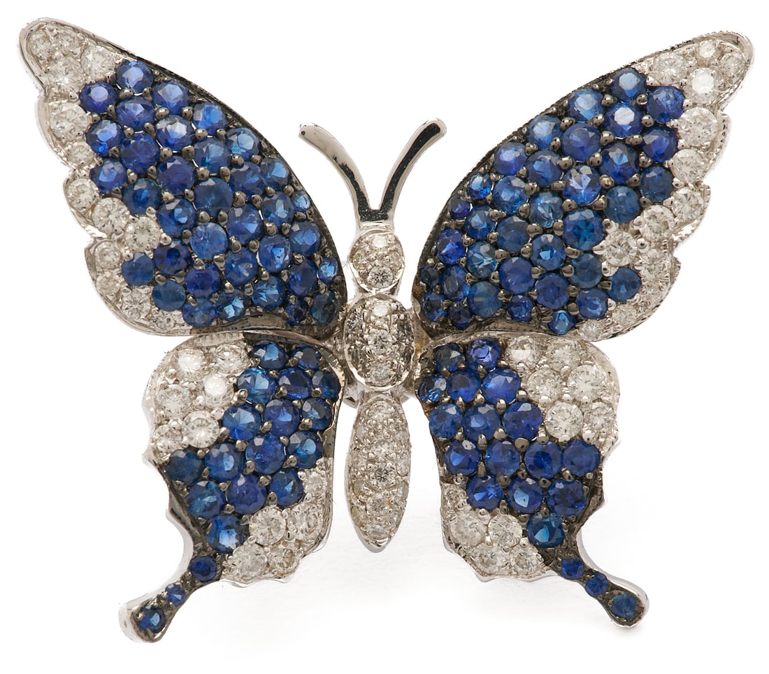 18K Gold, Diamond & Sapphire Butterfly Brooch: Ladies' 18K white gold brooch featuring one hundred eight (108) natural round cut sapphires accented by seventy (70) round brilliant cut melee diamonds. The brooch is marked "18K iJ" and