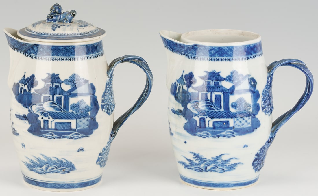 2 Large Chinese Export Nanking Cider Pitchers: A near pair of two (2) tall Chinese Nanking or Canton porcelain cider jugs or pitchers, each having underglaze blue and white decoration of pagodas overlooking boats at sea and a spearhead border, and