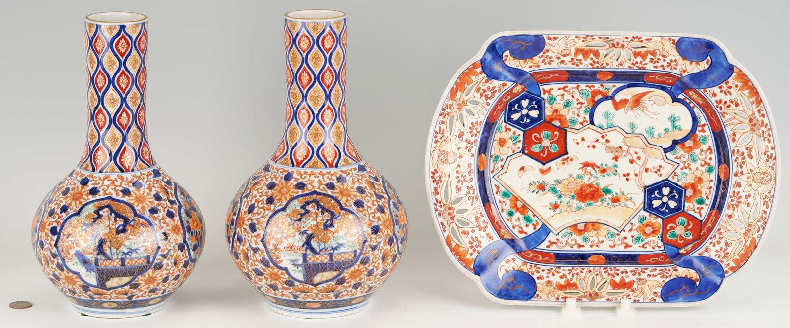 Pair of Imari Baluster Vases, Plus Reticulated Platter: Three (3) pieces of Japanese Imari Porcelain. 1st - 2nd Items: A pair of baluster shaped vases, in colors of orange, blue, and gold, having 2 panels of florals alternating with 2 panels of a tree and 