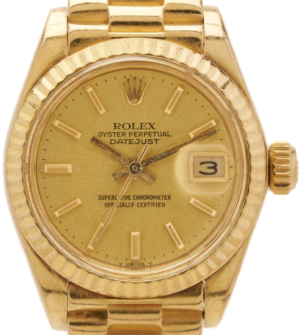 Ladies' 18K Gold Rolex Oyster Perpetual Datejust Wristwatch: Ladies' 18K Rolex yellow gold Oyster Datejust wristwatch, 26mm, reference # 6917, serial # 7394101, automatic movement with date, champagne dial with bar hour markers, 18K yellow gold Pr