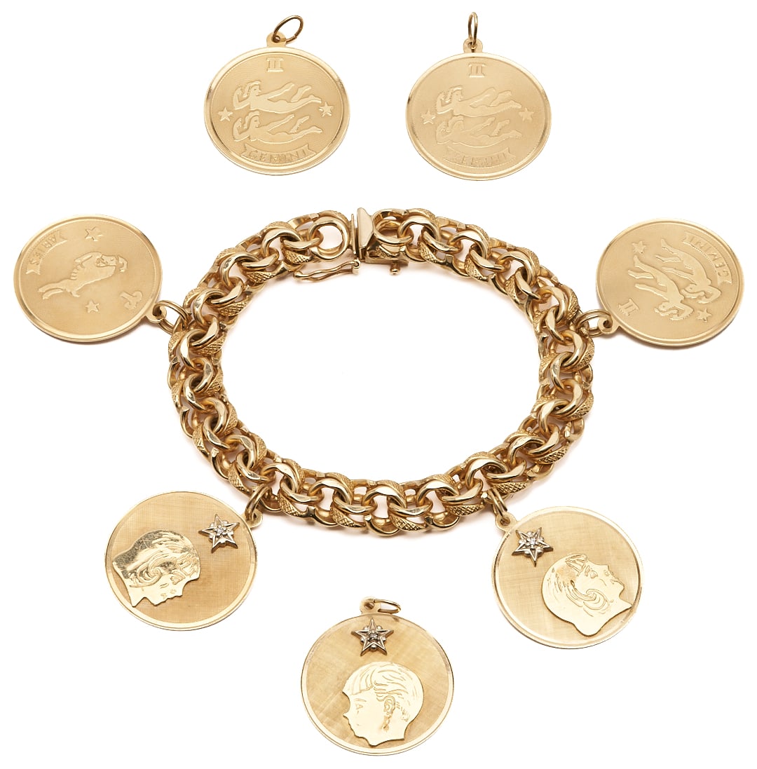 Vintage 14K Disc Charm Bracelet: Vintage 14K yellow gold charm bracelet featuring 7 charms, including three with profiles of young girls or boys with a single diamond set into a star, and four with zodiac signs. The bracelet and char