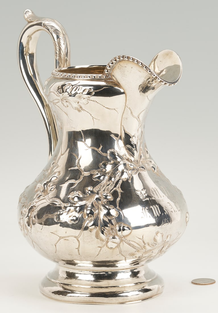 Boston Coin Silver Pitcher c. 1854: American coin silver water pitcher, pear-shaped form with beaded rim, chased and engraved foliate decoration, and central cartouche monogrammed E.M.R. from F.W. & A.L. 1854. Stamped in rectangles: