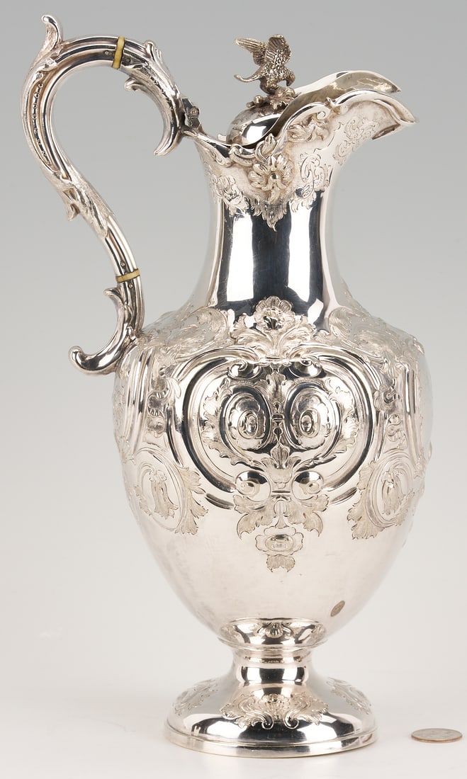Coin Silver Ewer w/TN history, Crest of Cummings or Cumyns Family: American coin silver ewer or covered pitcher with figural bird finial to lid, foliate C-scroll handle, and a Rococo Revival style body with repousse floral and cartouche decorations, supported on a do