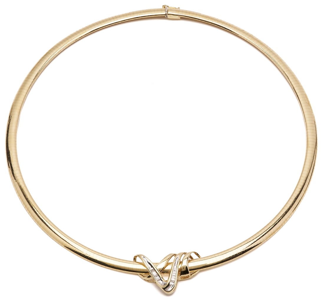 14K Domed Omega Necklace w/ 10K Chanel Set Baguette Slide: One 14K yellow gold domed omega necklace with a 10K yellow gold slide, accented by 16 tapered baguette diamonds totaling approximately 0.33 carats, graded G-H color and SI1 clarity. Necklace marked 14