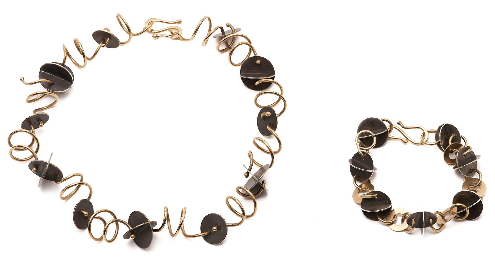 Marilyn Bailey Mixed Metal Coil Necklace & Bracelet: 1st item: Marilyn Bailey designer mixed metal necklace consisting of sterling 3D discs connected by 14K yellow gold links. The necklace measures 16 1/2 in. L. and has a gross weight of 65.3 grams. 2nd